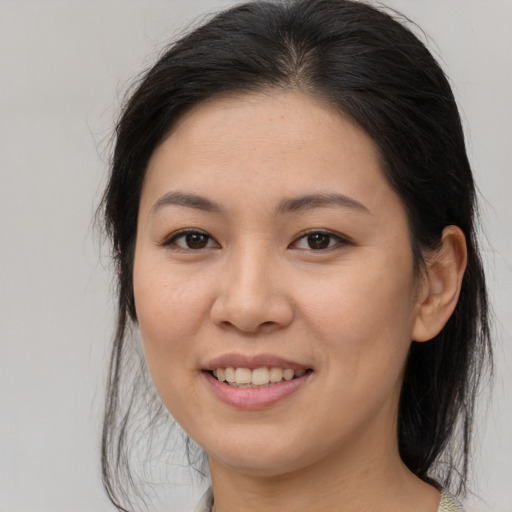 Joyful white young-adult female with medium  brown hair and brown eyes