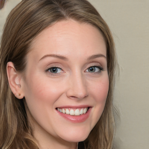 Joyful white young-adult female with long  brown hair and blue eyes