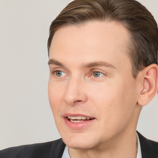 Joyful white adult male with short  brown hair and brown eyes