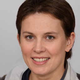 Joyful white adult female with medium  brown hair and brown eyes