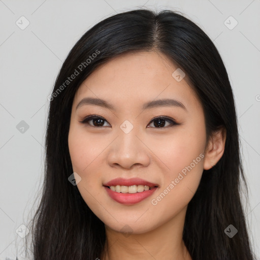 Joyful asian young-adult female with long  brown hair and brown eyes