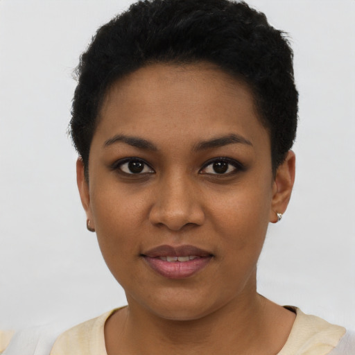 Joyful black young-adult female with short  black hair and brown eyes