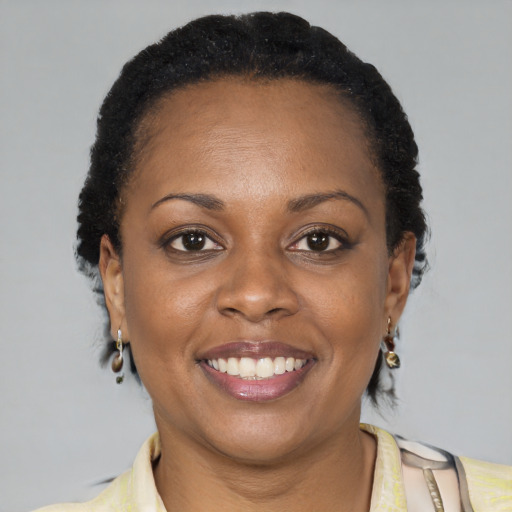 Joyful latino adult female with short  black hair and brown eyes