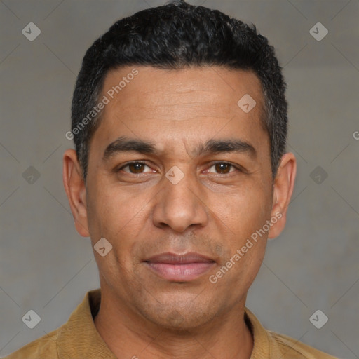 Joyful latino adult male with short  black hair and brown eyes