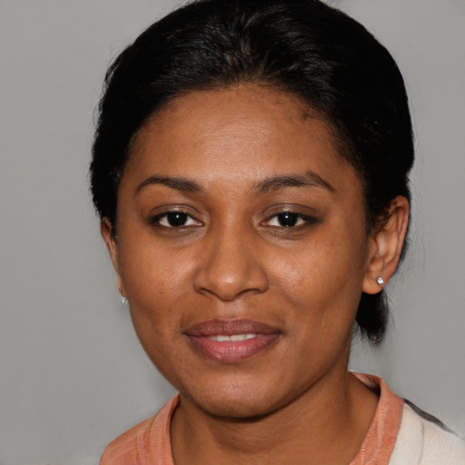 Joyful black adult female with short  black hair and brown eyes