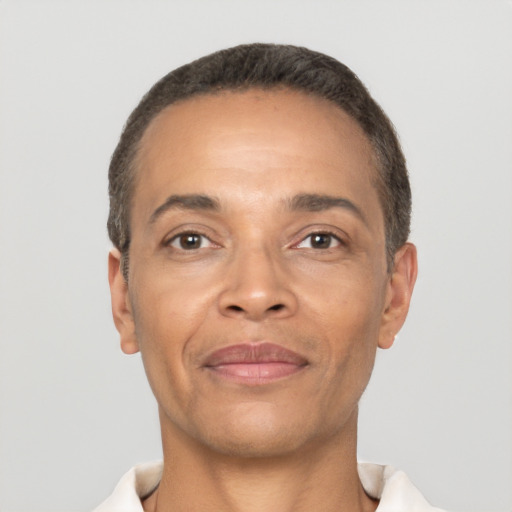 Joyful latino adult male with short  brown hair and brown eyes