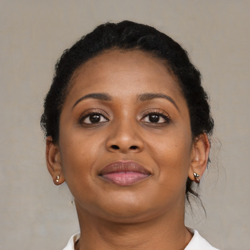 Joyful black young-adult female with short  brown hair and brown eyes
