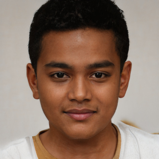 Joyful black child male with short  black hair and brown eyes