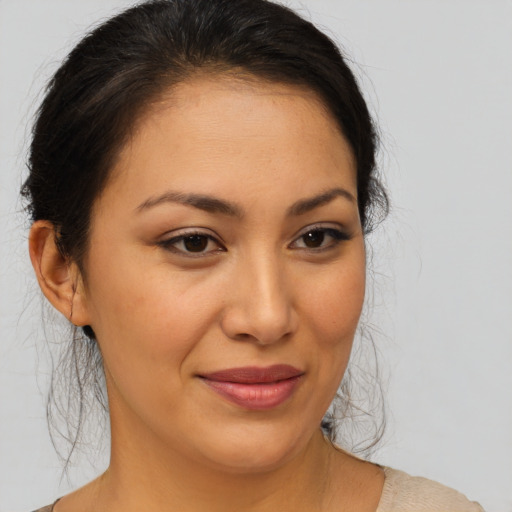 Joyful latino young-adult female with medium  brown hair and brown eyes