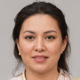 Joyful white young-adult female with medium  brown hair and brown eyes