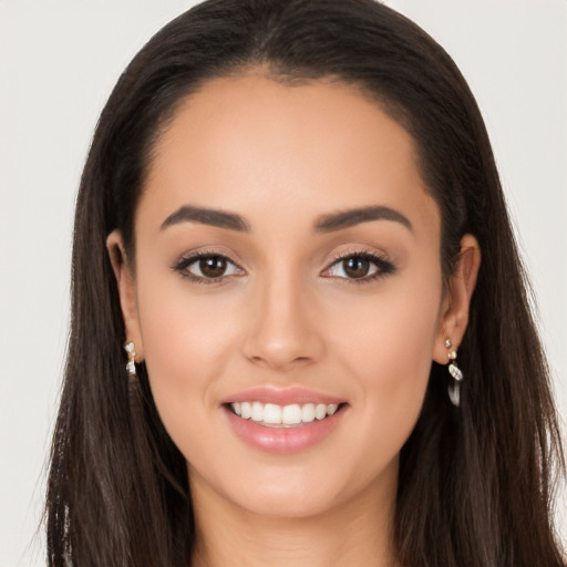 Joyful white young-adult female with long  brown hair and brown eyes