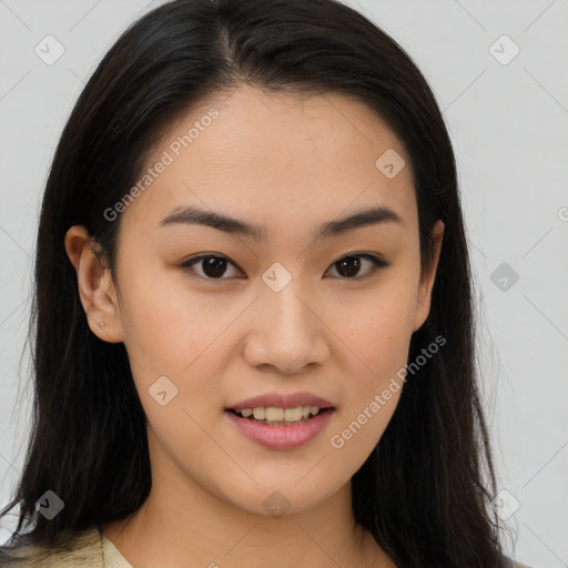 Joyful asian young-adult female with long  brown hair and brown eyes