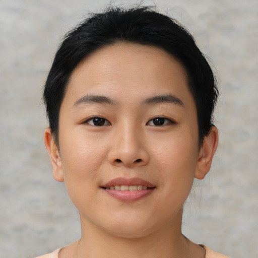 Joyful asian young-adult female with short  black hair and brown eyes