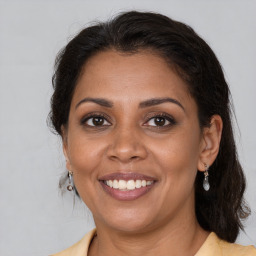 Joyful black young-adult female with medium  brown hair and brown eyes