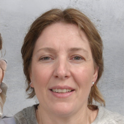 Joyful white adult female with medium  brown hair and blue eyes