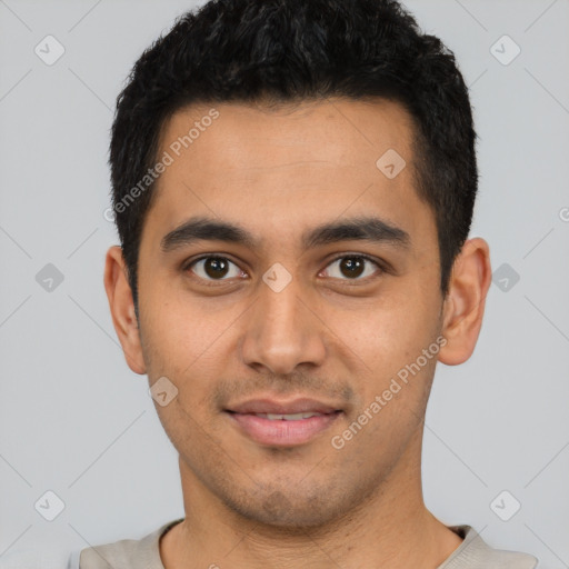 Joyful latino young-adult male with short  black hair and brown eyes