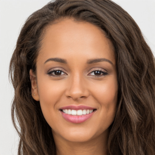 Joyful white young-adult female with long  brown hair and brown eyes