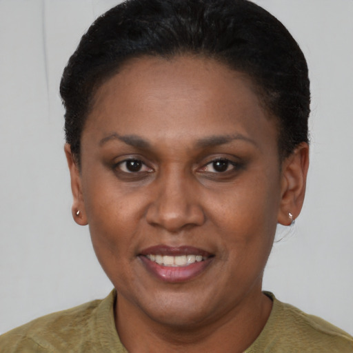 Joyful latino adult female with short  brown hair and brown eyes
