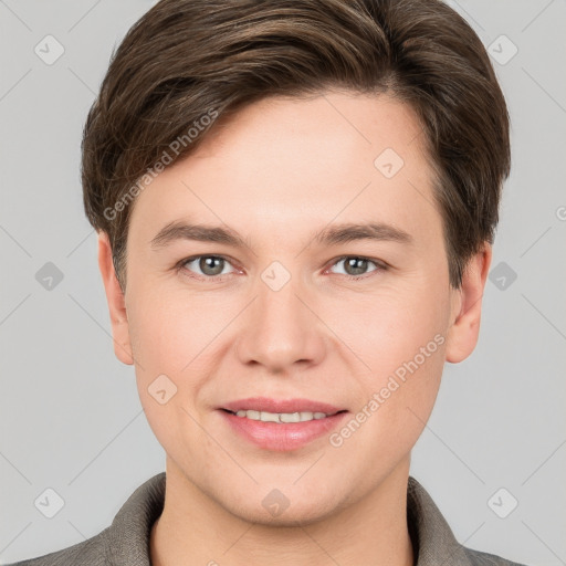 Joyful white young-adult male with short  brown hair and grey eyes