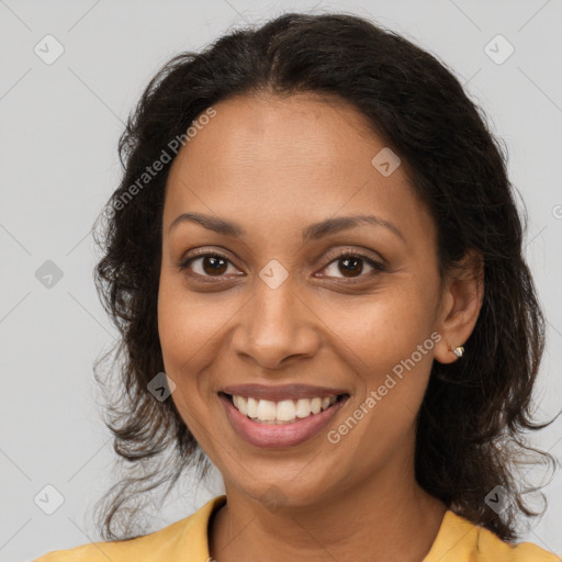 Joyful black young-adult female with medium  brown hair and brown eyes