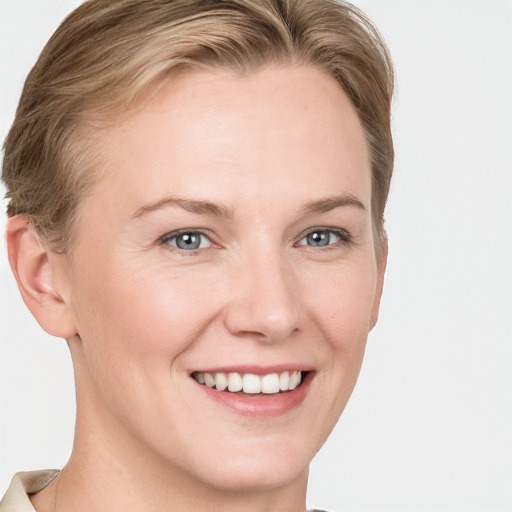 Joyful white young-adult female with short  brown hair and blue eyes