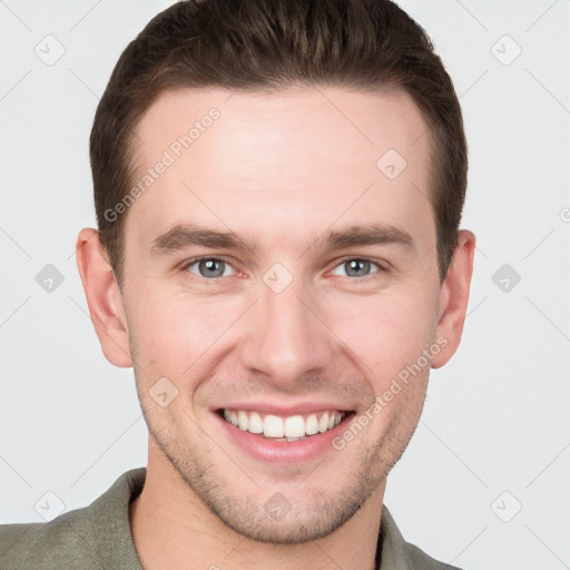 Joyful white young-adult male with short  brown hair and grey eyes