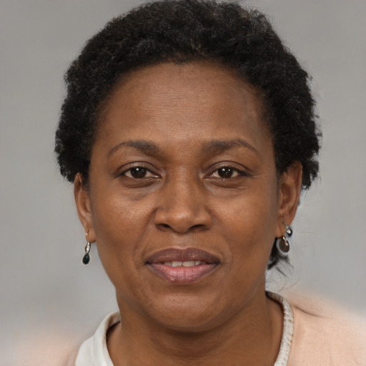 Joyful black adult female with short  brown hair and brown eyes