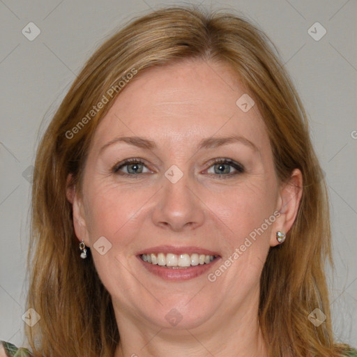 Joyful white adult female with long  brown hair and blue eyes