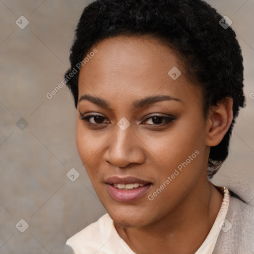 Joyful black young-adult female with short  black hair and brown eyes