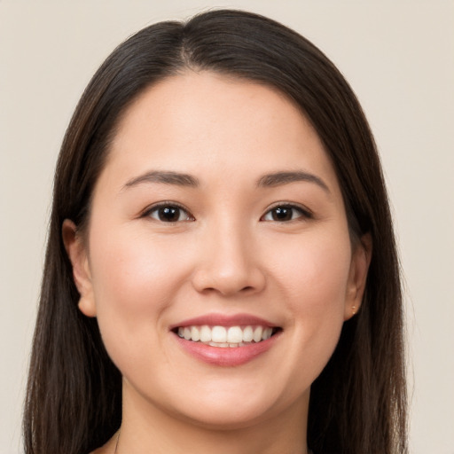 Joyful white young-adult female with long  brown hair and brown eyes