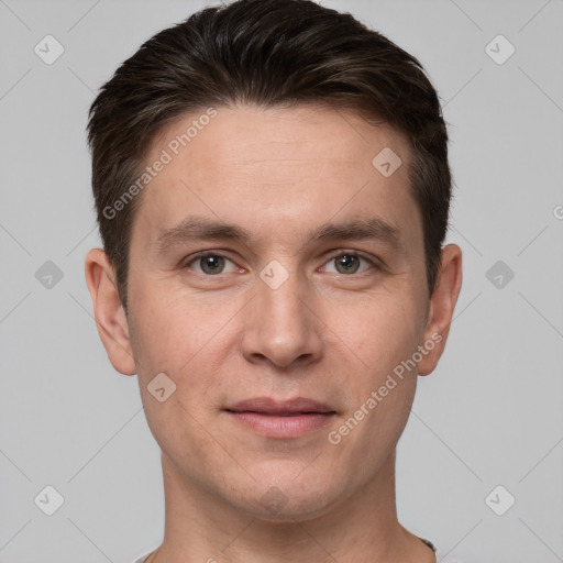 Joyful white young-adult male with short  brown hair and grey eyes