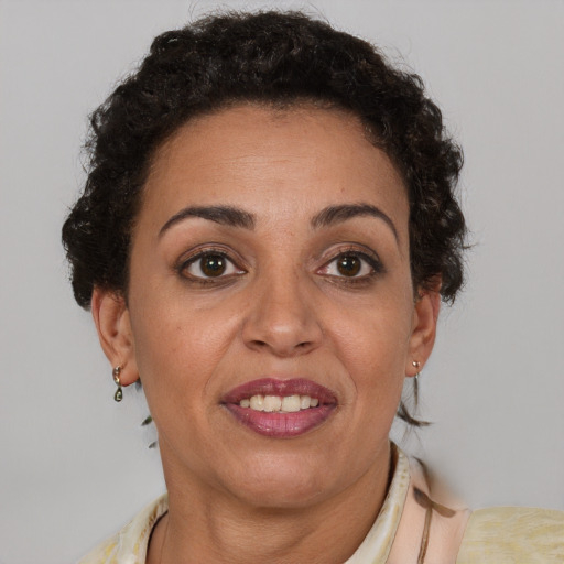 Joyful latino adult female with short  brown hair and brown eyes
