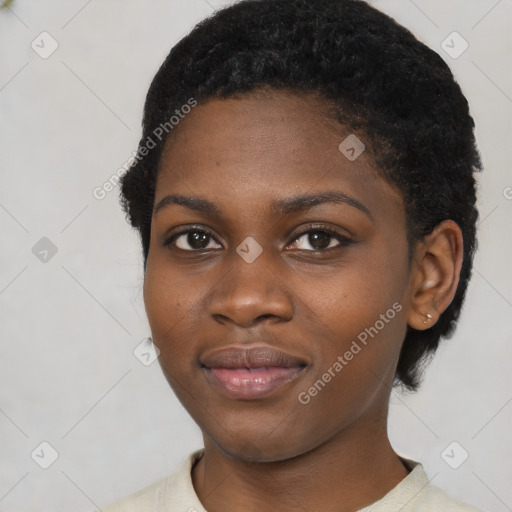 Joyful black young-adult female with short  black hair and brown eyes