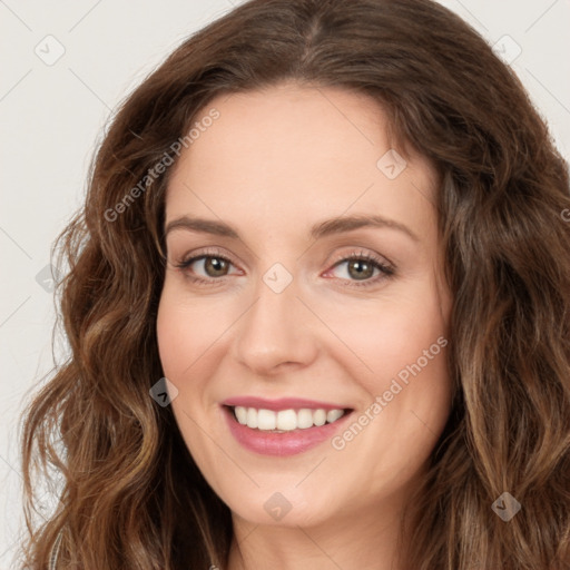 Joyful white young-adult female with long  brown hair and green eyes