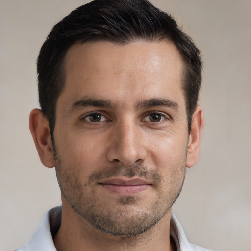 Joyful white adult male with short  brown hair and brown eyes