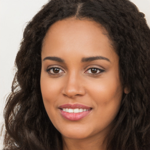 Joyful latino young-adult female with long  brown hair and brown eyes