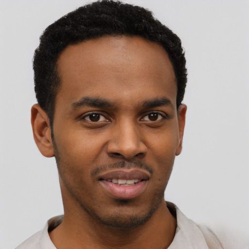 Joyful black young-adult male with short  brown hair and brown eyes