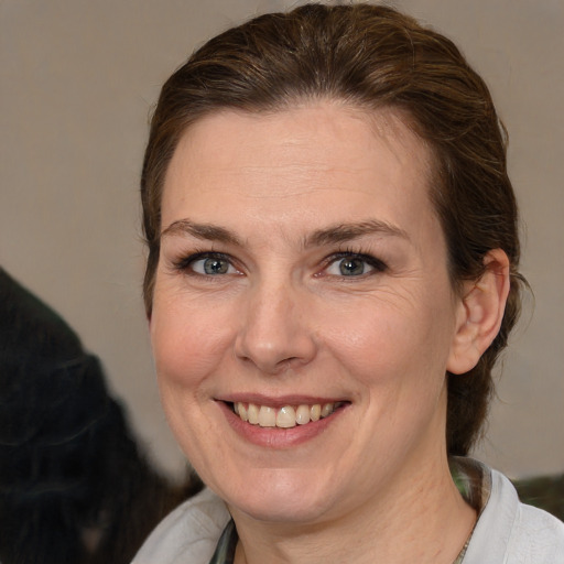 Joyful white adult female with medium  brown hair and brown eyes