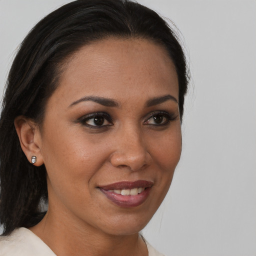 Joyful black young-adult female with medium  brown hair and brown eyes