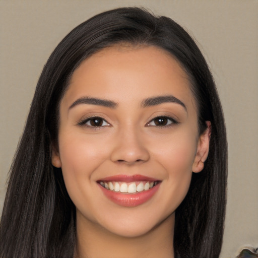 Joyful latino young-adult female with long  black hair and brown eyes