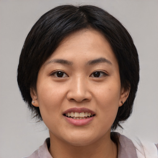 Joyful asian young-adult female with medium  black hair and brown eyes