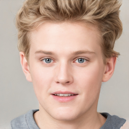 Joyful white young-adult male with short  brown hair and blue eyes