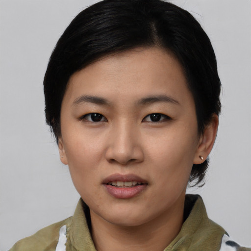 Joyful asian young-adult female with short  black hair and brown eyes