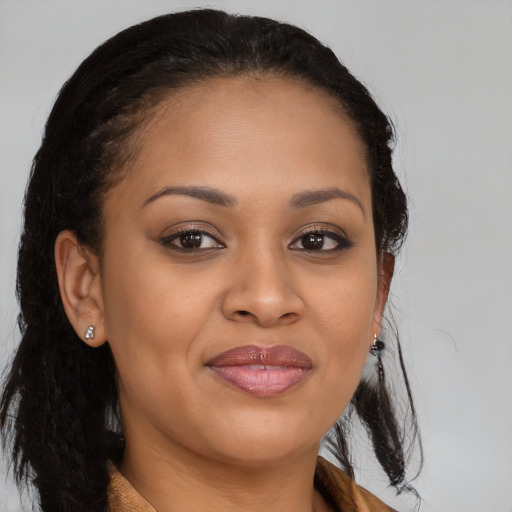 Joyful black young-adult female with long  brown hair and brown eyes