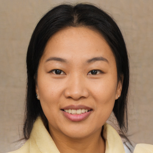 Joyful asian young-adult female with medium  brown hair and brown eyes