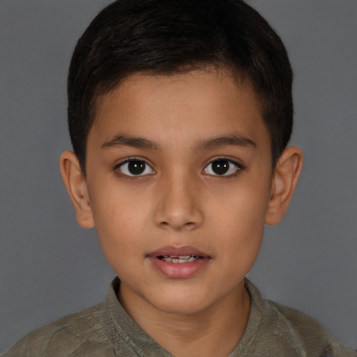 Joyful latino child male with short  brown hair and brown eyes