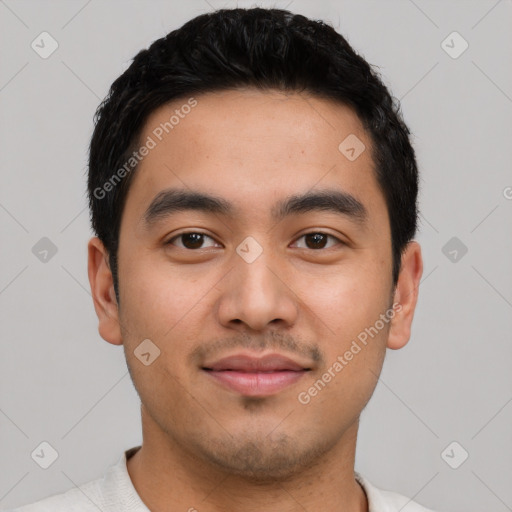 Joyful latino young-adult male with short  black hair and brown eyes