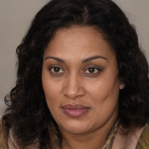 Joyful white adult female with long  brown hair and brown eyes