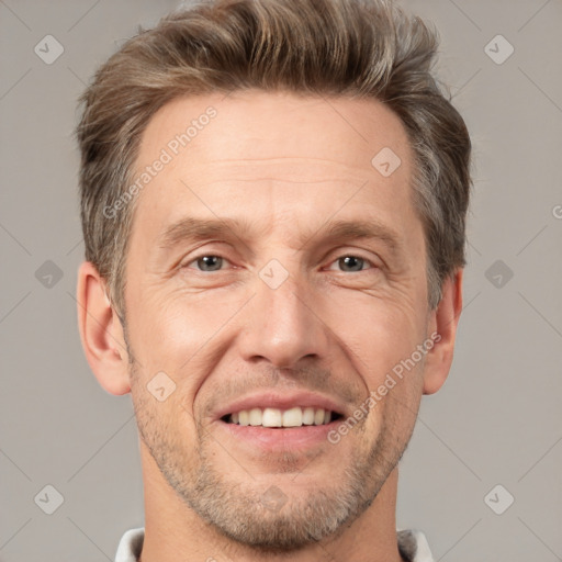 Joyful white adult male with short  brown hair and grey eyes