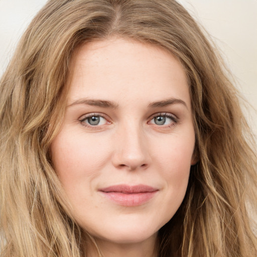 Joyful white young-adult female with long  brown hair and green eyes